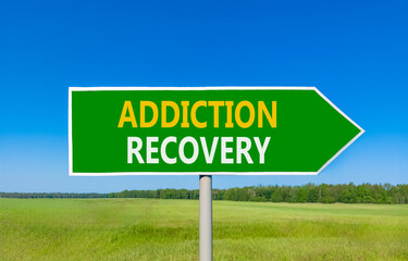 Addiction recovery symbol. Concept words Addiction recovery on beautiful green road sign. Beautiful blue sky green grass field background. Psychology addiction recovery concept. Copy space.