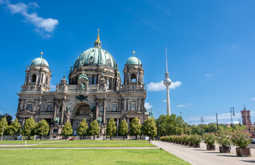 Berlin, germany, august 15, 2023. Berlin cathedral and the fernsehturm standing tall against a vibrant blue sky, highlighting german architecture and travel destinations © Massimo Parisi