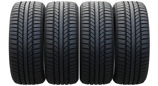 Four black tires with deep treads lined up side by side on a plain surface from a straight-on viewpoint