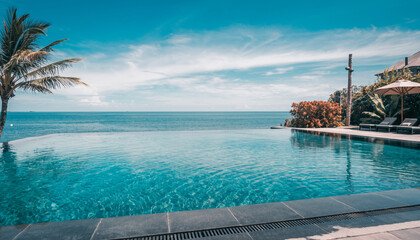 Obraz premium Infinity pool with clear blue waters overlooking the serene ocean and palm trees on a sunny day