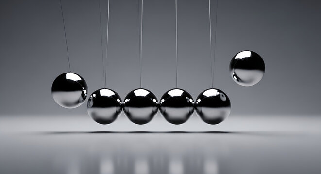 Scientific physics apparatus depicting momentum with a polished steel Newton's cradle metallic pendulum arrangement against a uniform minimalist gray studio backdrop for education and concept