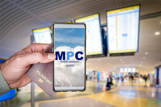 Traveler holding a passport and smartphone with the Mobile Passport Control - MPC - app displayed on screen, streamlining the immigration process at an international airport