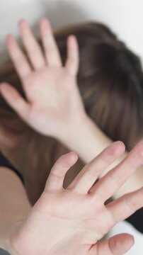 Violent man attacking woman, showing conflict and oppression. Dramatic scene of abuse and intimidation. Footage emphasizes stop violence message. Vertical video.