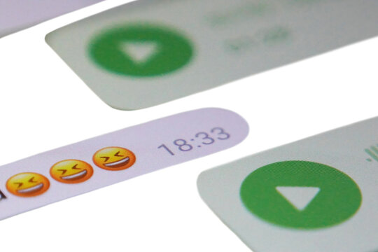 WhatsApp chat screen with laughing emojis. Multiple yellow laughing face emojis (😂😂😂) at 18:33 timestamp on green background. Green play buttons and message bubbles visible.
