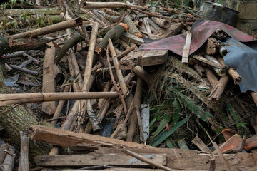Pile of chopped wood branches bamboo poles and construction debris