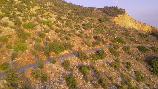 Female with Overweight Doing Cardio Training by Running in Mountains During Evening Time, drone view