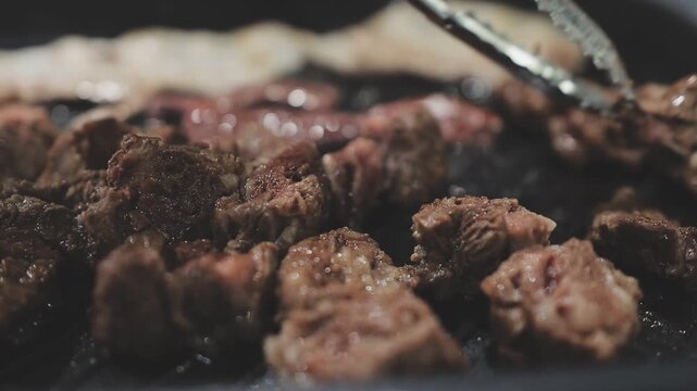 Galbi sizzling Korean BBQ experience showing dynamic cooking action with smoke and grill marks for authentic restaurant scene.