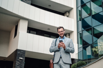 Businessman using smartphone interacting with modern technology