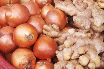 Onion bulbs and fresh ginger close up