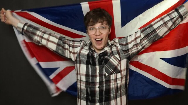 Young attractive male fan waving a flag