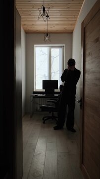 Young man walking back and forth in home office, work burnout, stress and anxiety, remote job problems, freelancer lifestyle, real life scene. Vertical video