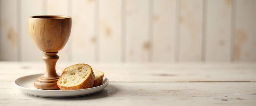 Wooden chalice with bread on a plate in minimalist setting for Maundy Thursday  