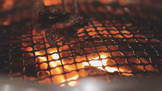 Galbi sizzling Korean BBQ experience showing dynamic cooking action with smoke and grill marks for authentic restaurant scene.