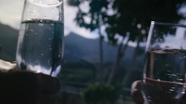 Two Glasses of Cold Champagne Toasting with Stunning Mountains in the Distance