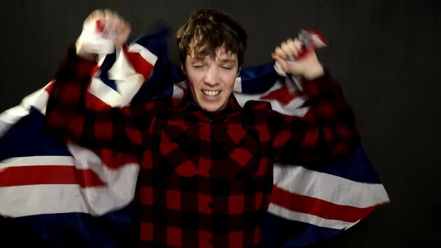 Young attractive male fan waving a flag