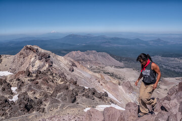 Fototapeta premium A woman is running up a mountain