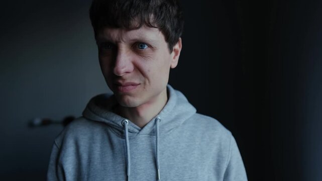 Man checking his breath before social interaction, breathing into hand and reacting to unpleasant smell, concern about first impression, dating anxiety and personal hygiene