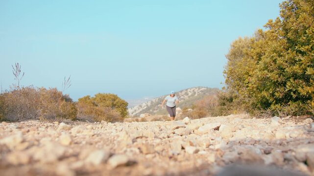 Adult Woman Running in Cool Evening Weather in Mountain Area Pursuing Health and Wellness