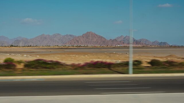 View from the window of an moving  touristic bus. The bus is driving along the Ibn Sina road. Action takes place near Saint Catherine Protectorate, an Egyptian national park in the south of Sinai.