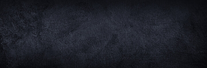 Fototapeta premium Black dark gray graphite blue texture background. Painted concrete wall surface. Grunge old rough uneven plaster scratched damaged. Close-up. Empty blank minimal template design ad. Wide banner. 