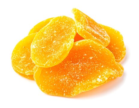 Pile of dried mango slices, glistening with sugar, isolated on a white background