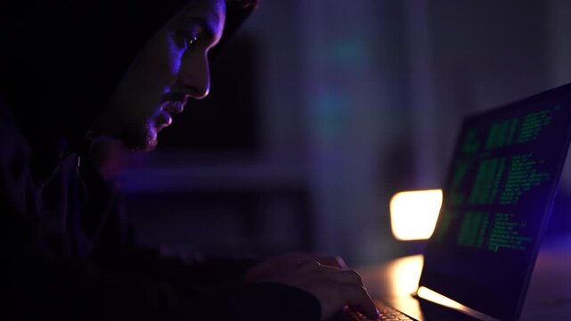 Cybersecurity professional executing penetration testing protocols on laptop. Ethical hacker typing malicious code syntax during targeted network vulnerability assessment.