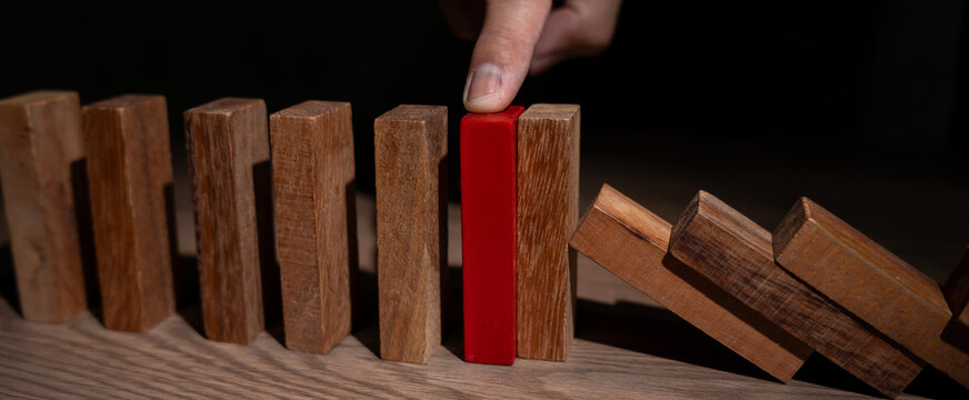 insurance with hands protect domino. Businessman hands stop dominoes falling in business crisis. business risk control and planning and strategies to run prevent insurance businesses.