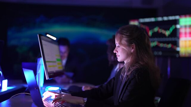 Senior software developers debugging complex backend cloud infrastructure code. Female data science engineers reviewing predictive AI algorithms on digital tablet and monitor.