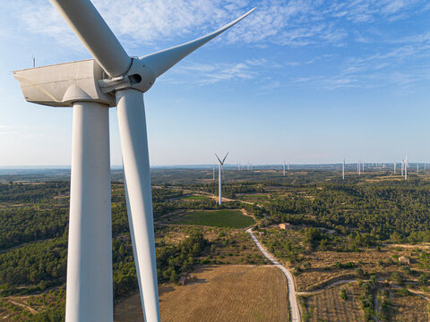 Aerial wind turbine blades and nacelle in Terra Alta Catalonia Spain supporting sustainable renewable energy generation from wind