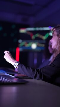 Cybersecurity analysts monitoring real-time network threat logs in dark security operations center. Digital forensic experts auditing malware code syntax during late night shift.