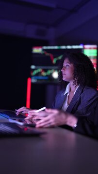 Senior software developers debugging complex backend cloud infrastructure code. Female data science engineers reviewing predictive AI algorithms on digital tablet and monitor.