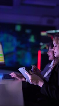 Female fintech data scientists analyzing real-time cryptocurrency market volatility charts. Quantitative analysts developing high-frequency algorithmic trading strategies on multi-screen dashboard set