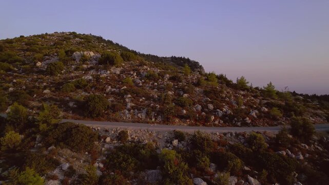 Female with Overweight Doing Outdoor Workout in Mountains Running at Sunset in Nature, drone view