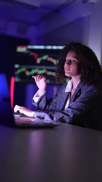 Female fintech data scientists analyzing real-time cryptocurrency market volatility charts. Quantitative analysts developing high-frequency algorithmic trading strategies on multi-screen dashboard set