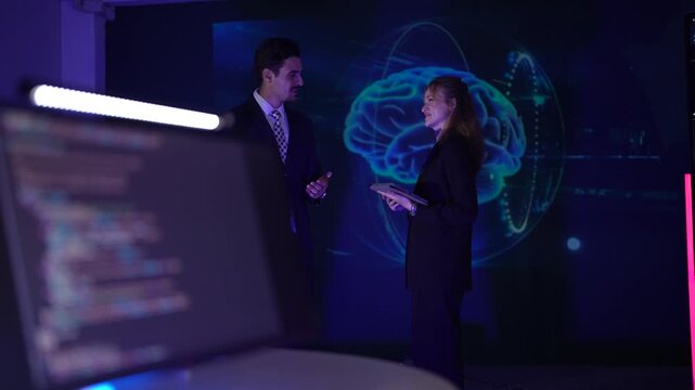Female software engineers reviewing complex code. Developer team debugging predictive analytics syntax with AI brain visualization in neon workspace.