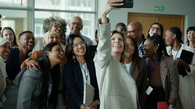 Diverse professionals smiling for a group selfie