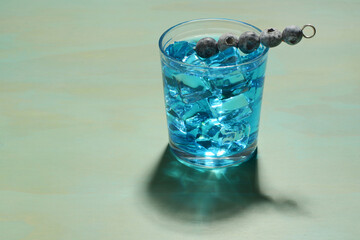 closeup of blue cocktail with blueberries