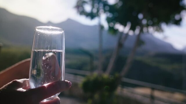Woman with Glass of Wine Relaxing and Conversing Against Beautiful Mountain Horizon