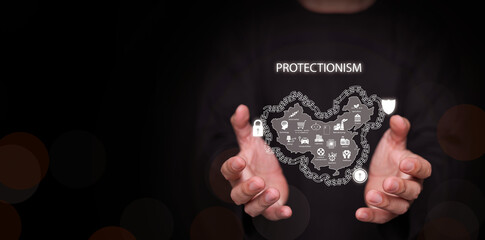 Protectionism concept. Hands holding a country surrounded by wall, lock, and shield protecting domestic industries in the country. Trade barriers, protective tariff, import quota, and subsidies.
