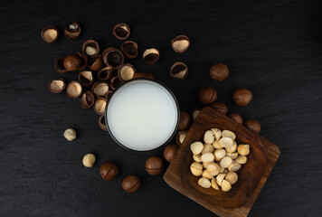 Macadamia nuts. Natural raw peeled macadamia seeds and shells