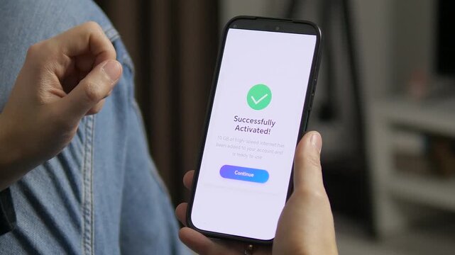 Close-up of smartphone screen showing successful mobile data activation. User confirms high-speed internet package in modern app interface. Perfect for telecom, 5G, connectivity, digital lifestyle and