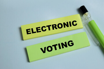 Fototapeta premium Concept of electronic voting write on sticky notes isolated on Wooden Table. Is voting that uses electronic means to either aid or take care of casting and counting ballots
