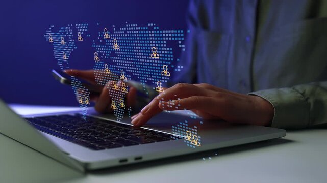 Hands using a laptop with a digital map showing people icons during a late-night project.