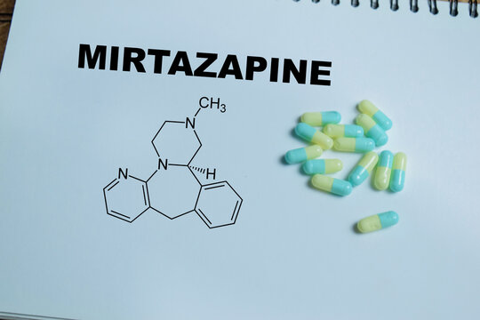 Concept of mirtazapine antidepressant medication write on book isolated on Wooden Table. Treatment of depression, anxiety and sleep disorders