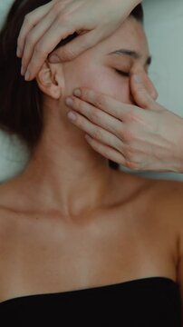 Esthetician sculpting massage caucasian woman facial contour