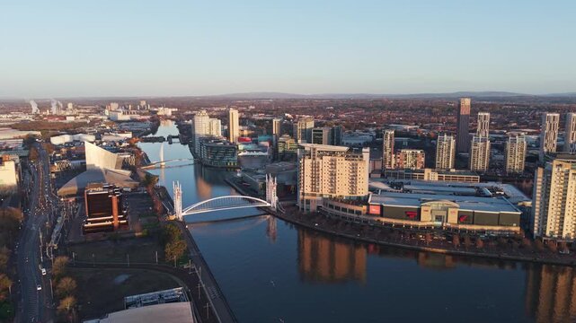 Cityscape of Millennium Bridge and quayside buildings, Salford Quays, Manchester, England
