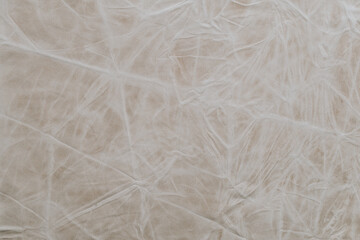 Obraz premium Wrinkled fabric texture shows light colors and patterns under natural light in a close-up view during daytime