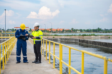 Environmental engineers work at wastewater treatment plants,Water supply engineering working at Water recycling plant for reuse,Technicians and engineers discuss work together.