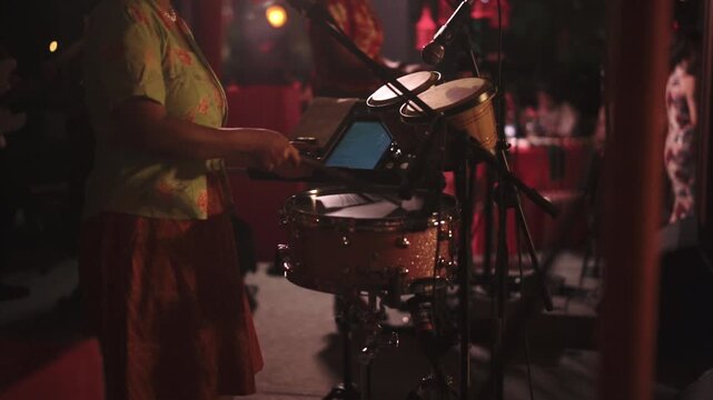 Close-up drummer playing drum in music concert or performance