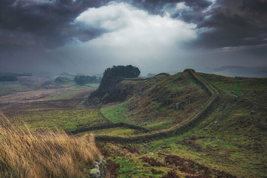 Storm clouds over Sewingshields Craggs, Hadrian's Wall, Northumberland, England. 73 miles long the wall was built to guard the north-west frontier of the Roman Empire and is a World Heritage Site